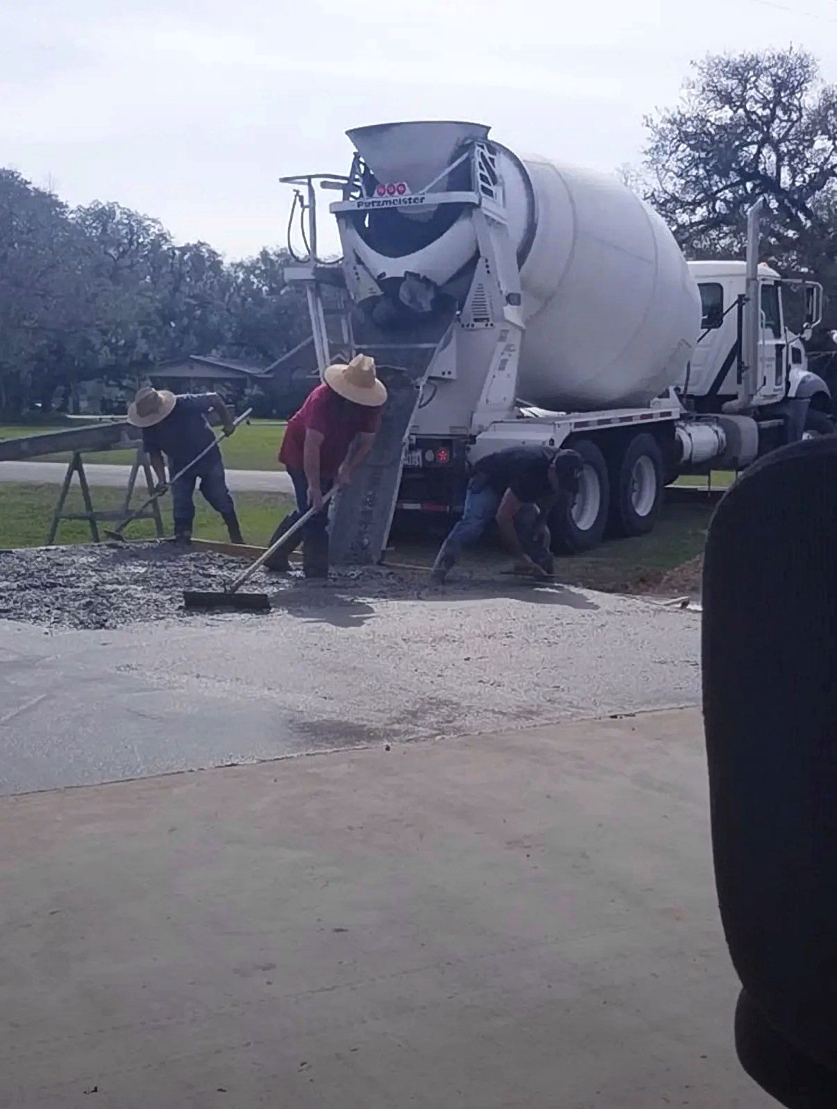 Crew pouring concrete from mixer truck